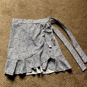 Mini skirt with front ruffle and side tie